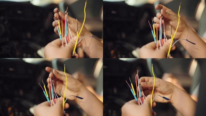 特写: 一名技术人员试图匹配许多电缆颜色，在连接到另一根电缆之前应用热缩管