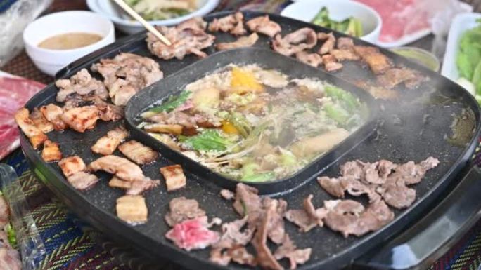 近距离欣赏韩国烧烤和sha锅晚餐的人们。