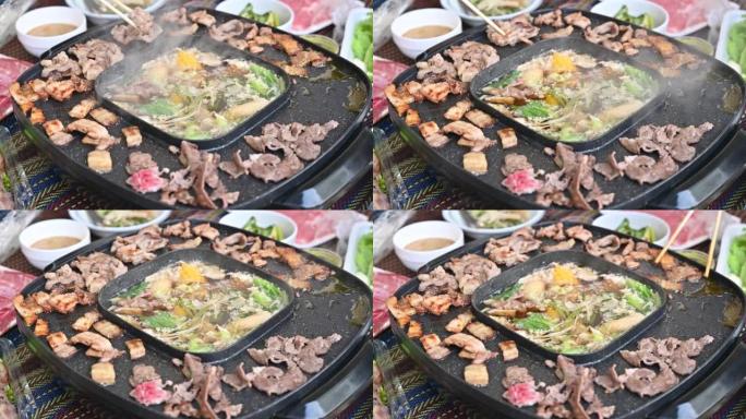 近距离欣赏韩国烧烤和sha锅晚餐的人们。