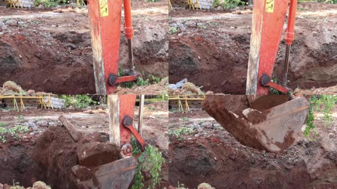 挖掘机铲斗在地面上挖了一个坑，用于铺设加热管