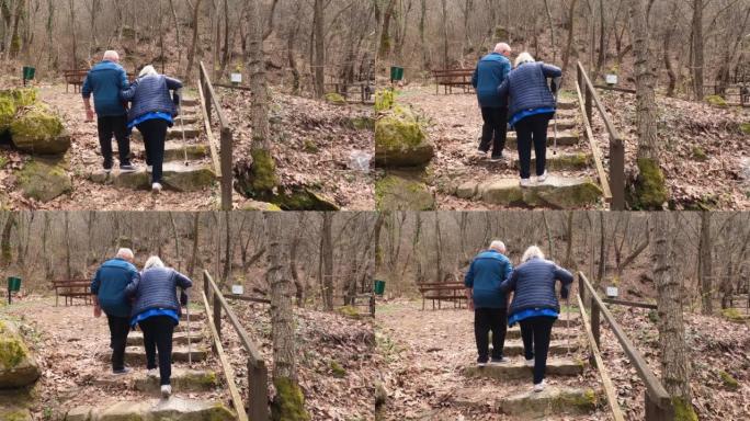 残疾的老年夫妇拄着拐杖在秋天的大自然中散步，慢动作