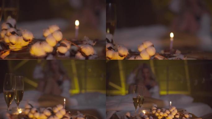 在床上享用香槟和蜡烛的浪漫晚餐