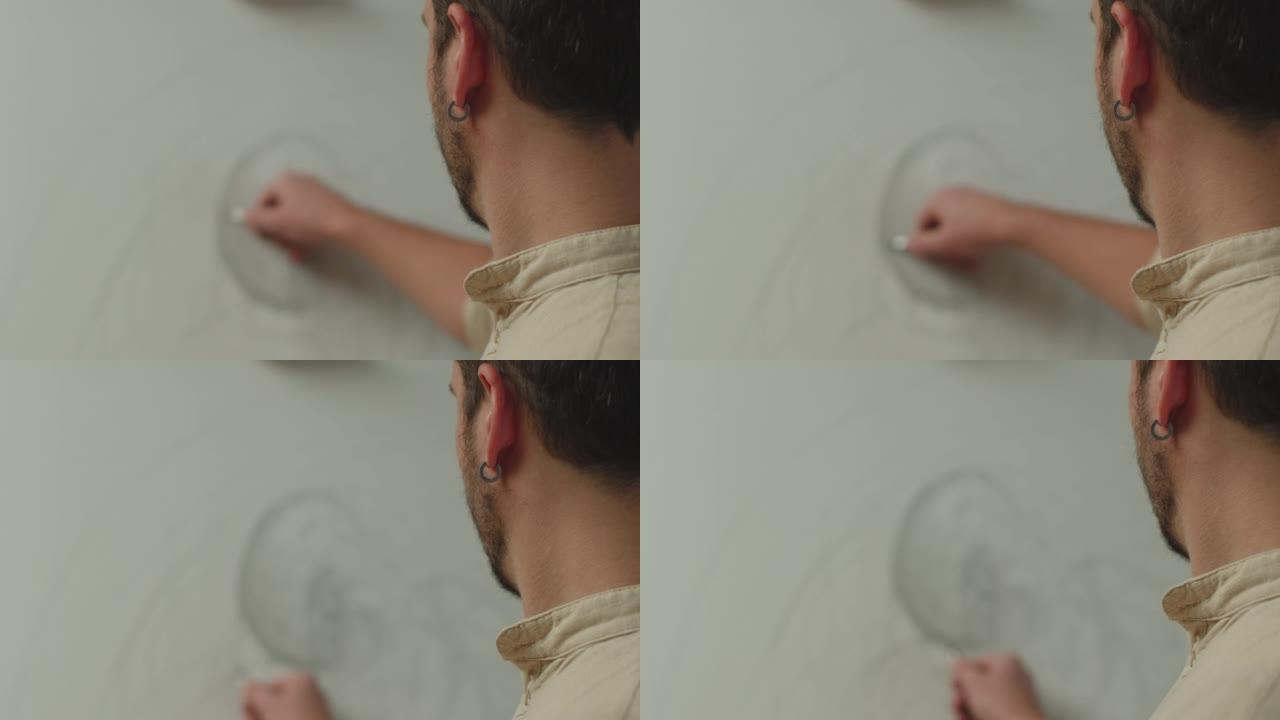 男性艺术家用铅笔在画布上绘画，创作杰作，特写后视图。Prores编解码器。绘画课
