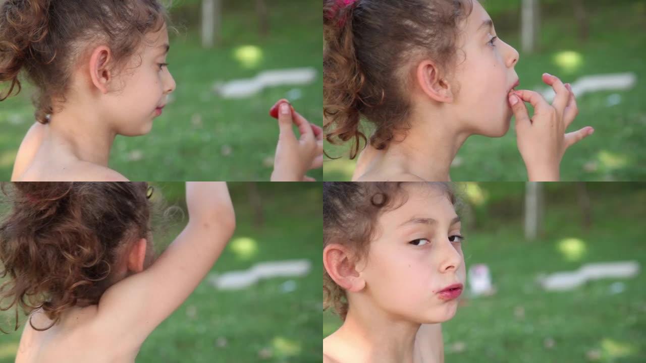一个小女孩在公园吃草莓的侧视图