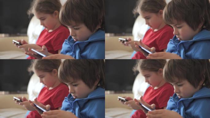 孩子们在家里的沙发上用手机玩游戏。孩子们在手机上玩视频游戏。男孩和女孩在沙发上玩视频游戏智能手机朋友