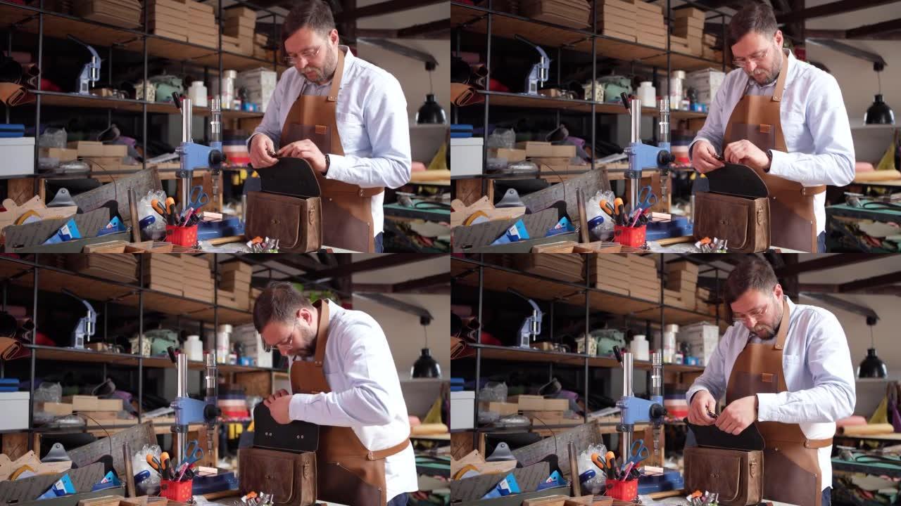 高加索男性裁缝在裁缝车间制作皮包