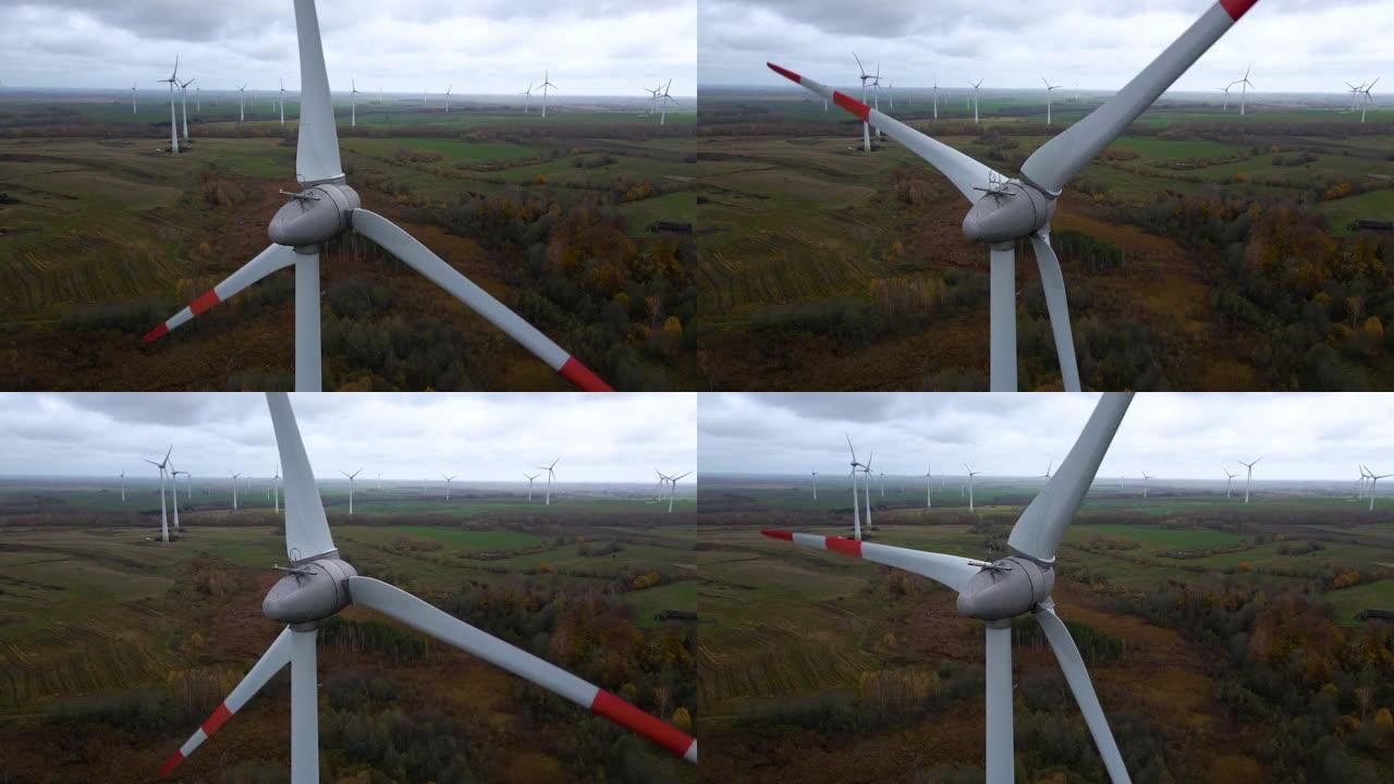 阴天在广大农村地区进行多个旋转风力涡轮机的航拍，用于可再生电力生产