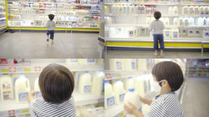 一个小男孩在超市的架子上捡到一加仑牛奶