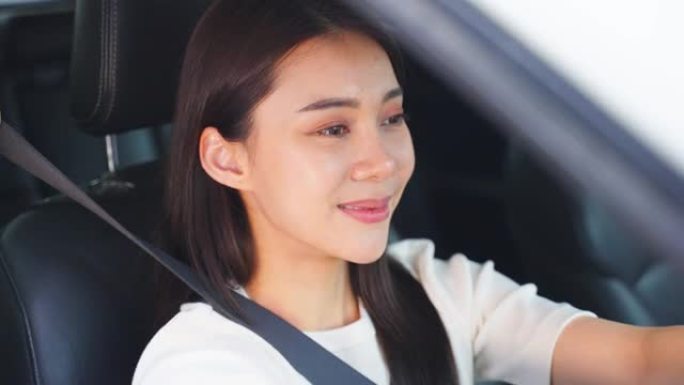 亚洲美女司机开车前系好汽车安全带。迷人的年轻女孩带着幸福和自信在车内系好安全带。保护安全驾驶理念。