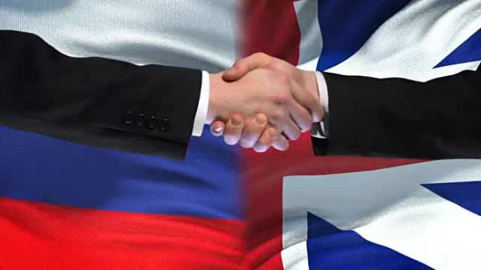 俄罗斯和英国握手，国际友谊，国旗背景