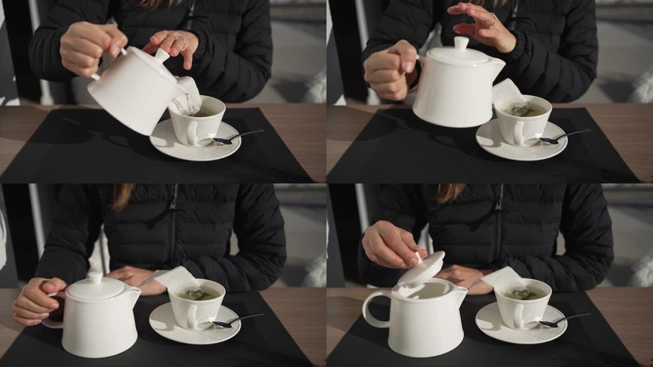 一名年轻女子倒水将茶倒入杯子的特写镜头