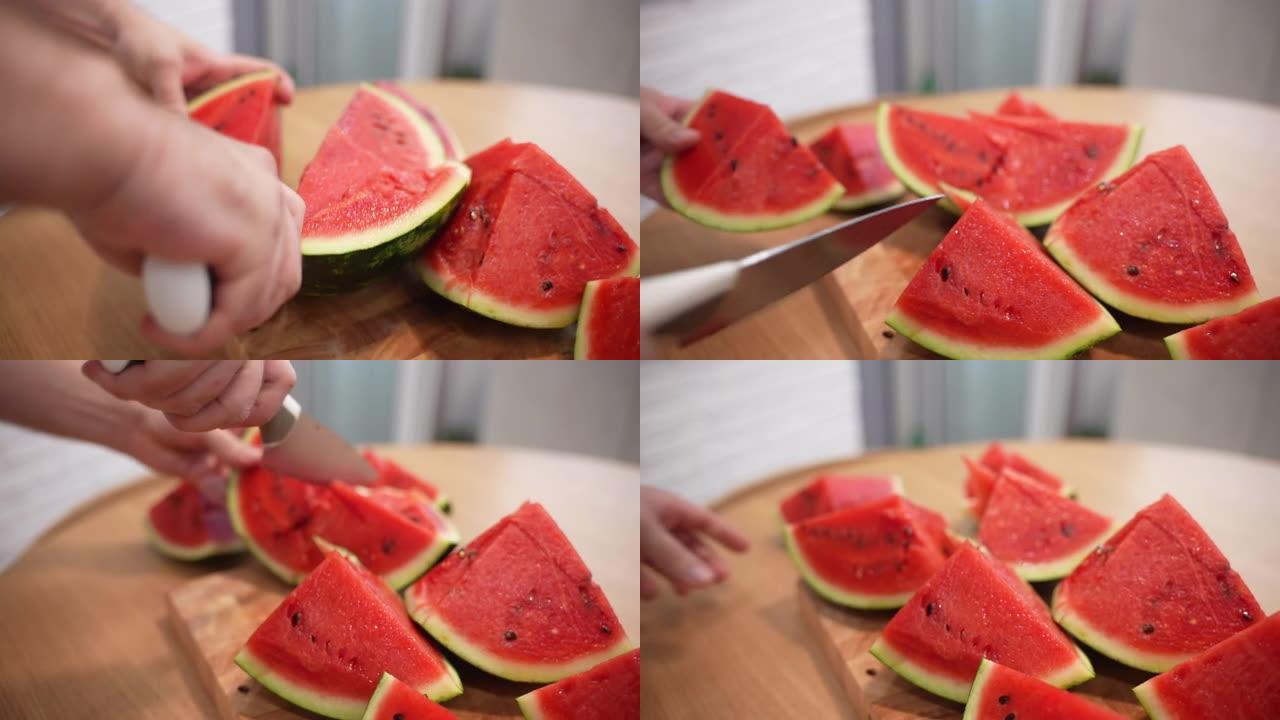 多汁的成熟西瓜在木板上切成小块，人用菜刀将夏季水果切成小块，开胃的红色西瓜，里面有黑色种子，水果收获