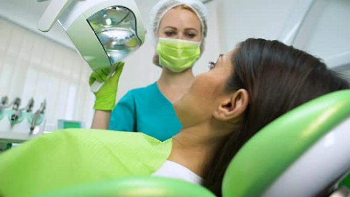 牙医治疗年轻女性的牙齿，龋齿去除，牙科密封剂放置