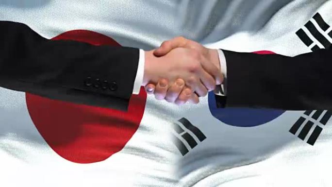 日本和韩国握手国际友谊峰会，旗帜背景