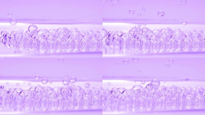 紫色透明气泡与另一个气泡一起沉入流体表面
