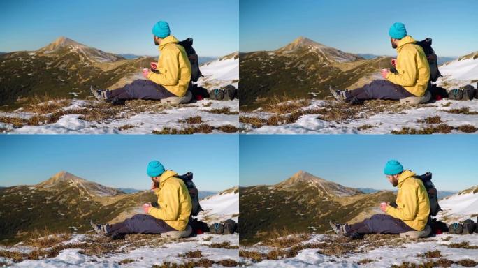 男性徒步旅行者在山顶享受小吃
