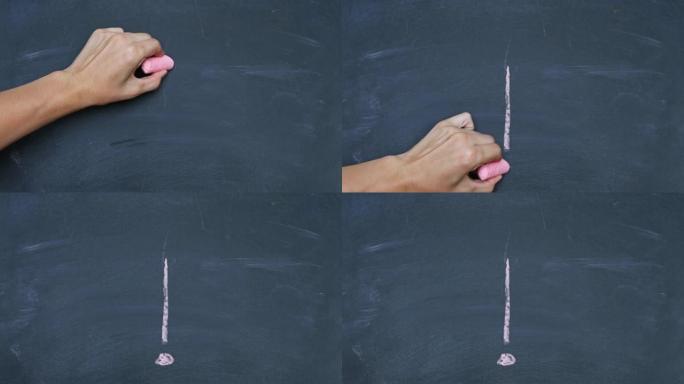一个男人的手在学校董事会上画了一个粉笔感叹号。用红色粉笔在黑板上手写。特写