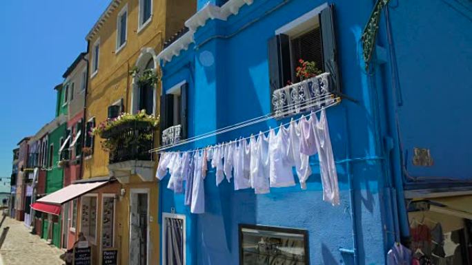 意大利生活布拉诺岛街蓝屋门面上的白色衣物烘干