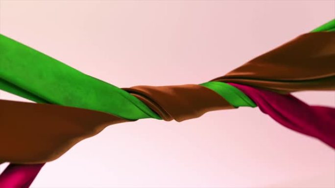 不同颜色的天鹅绒丝带在抽象的背景上紧密地缠绕在一起。绿色、棕色、紫色。