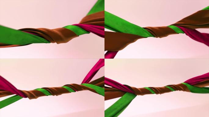 不同颜色的天鹅绒丝带在抽象的背景上紧密地缠绕在一起。绿色、棕色、紫色。