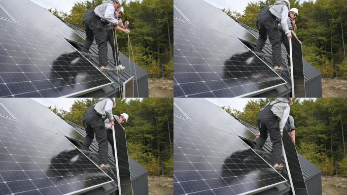 工人在屋顶安装太阳能电池板系统时抬起光伏太阳能组件。