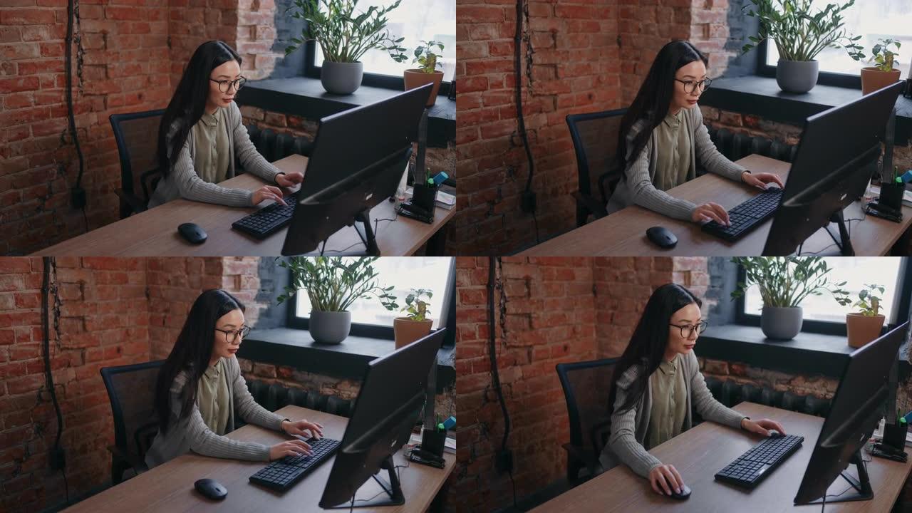 美丽的亚洲女性在办公室工作，会计师或财务分析师在计算机上做报告