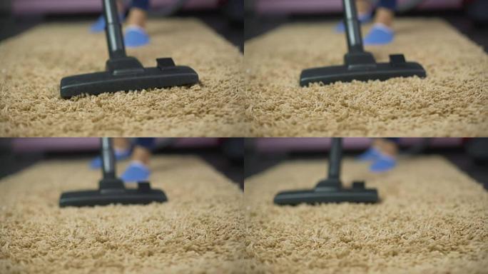 吸尘器扫除昂贵地毯上的灰尘的特写镜头，家庭卫生
