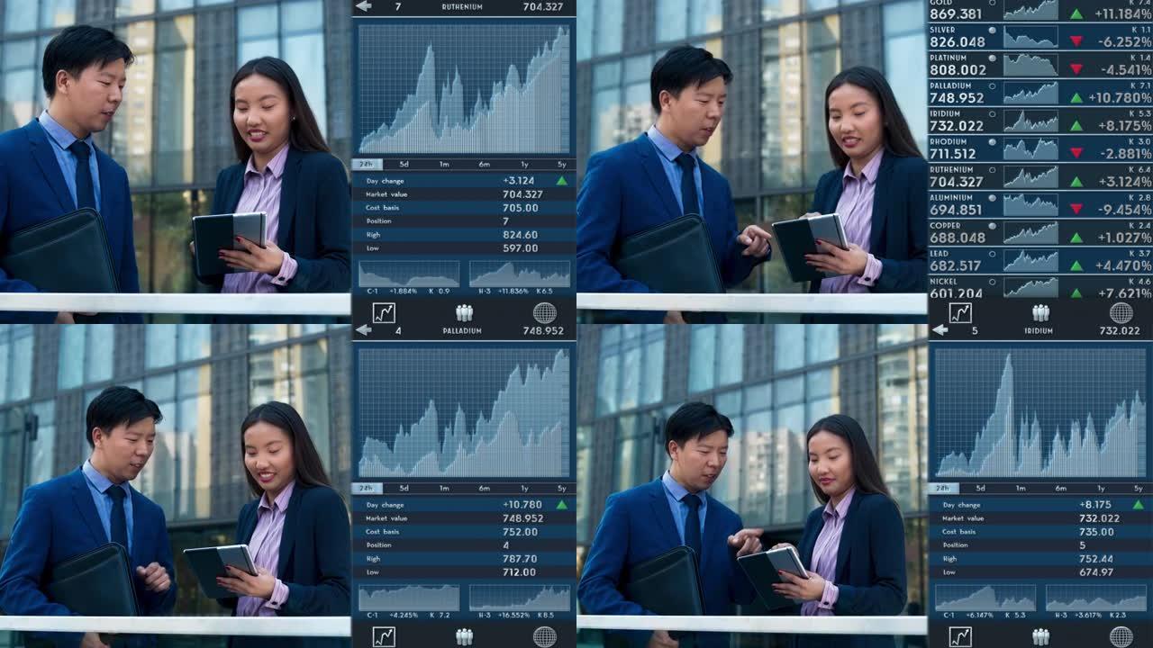DS亚洲女商人在商业大楼前的平板电脑上检查交易应用程序时与她的亚洲男同事交谈