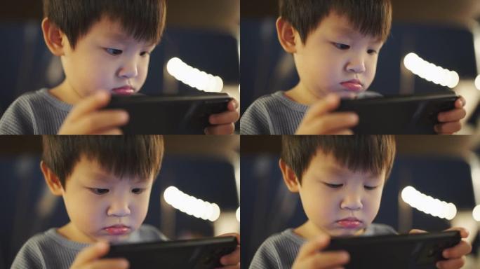 小男孩玩手机游戏小男孩电子幼儿