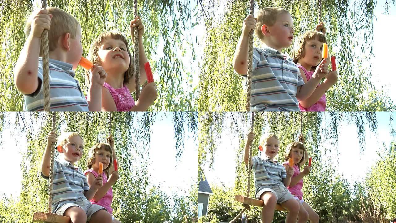 两个孩子坐在秋千上吃冰棍