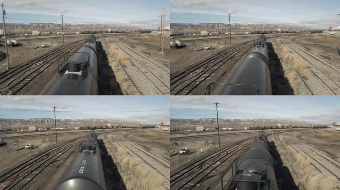 天然气和石油设备铁路汽车油罐在美国西部的农村小镇位置白天航空视频系列