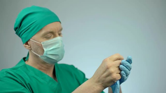 手术失败后，失望的外科医生脱下了医用手套
