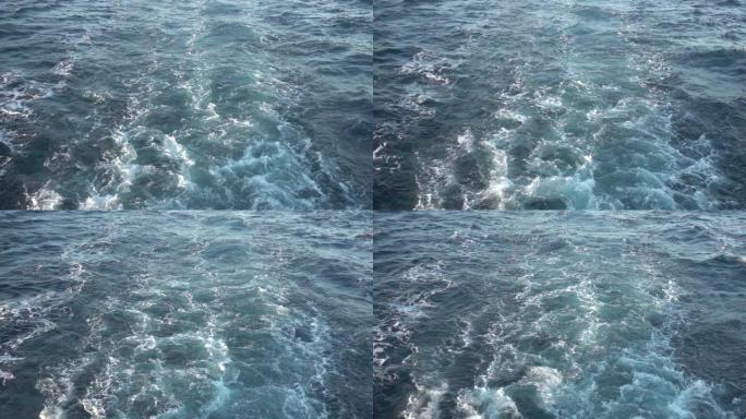 船只唤醒。船外宽阔的尾迹。后视图。海水。深蓝色。大船的痕迹。