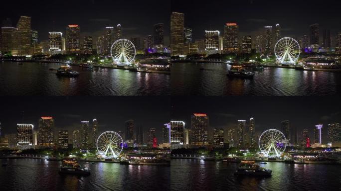 海滨市场迈阿密观景台的鸟瞰图，夜间在比斯坎湾水域和布里克尔市金融中心的高光摩天大楼中倒影