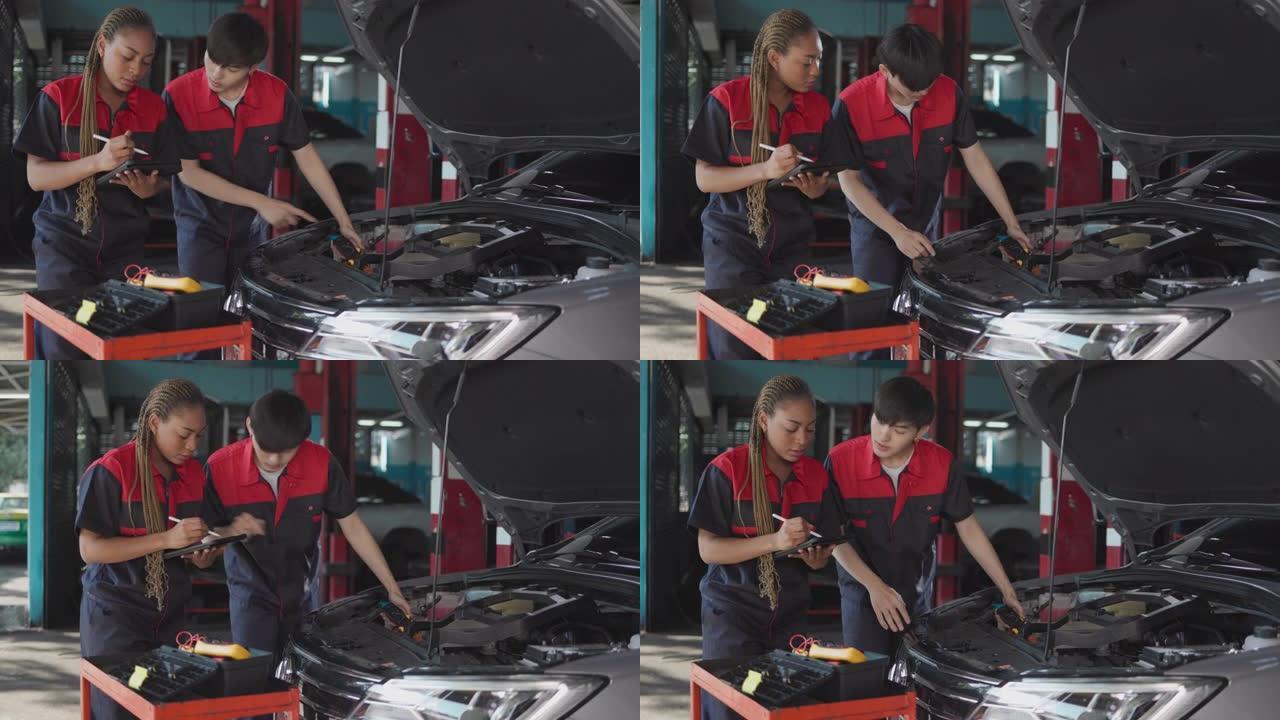 汽车服务、维修、保养理念。机械师在服务站检查汽车。工业到发动机维修的服务维护。非裔美国妇女和亚洲工程