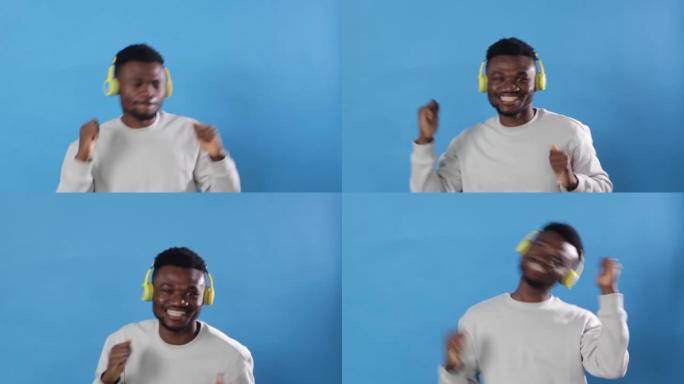 来自乌干达的一名非洲男子正戴着黄色耳机在蓝色背景上欢快地跳舞，欣赏有节奏的音乐。