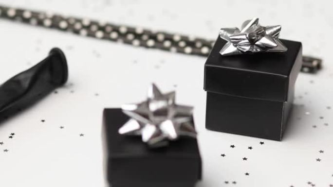 黑色和银色礼盒的节日生日派对背景轮换