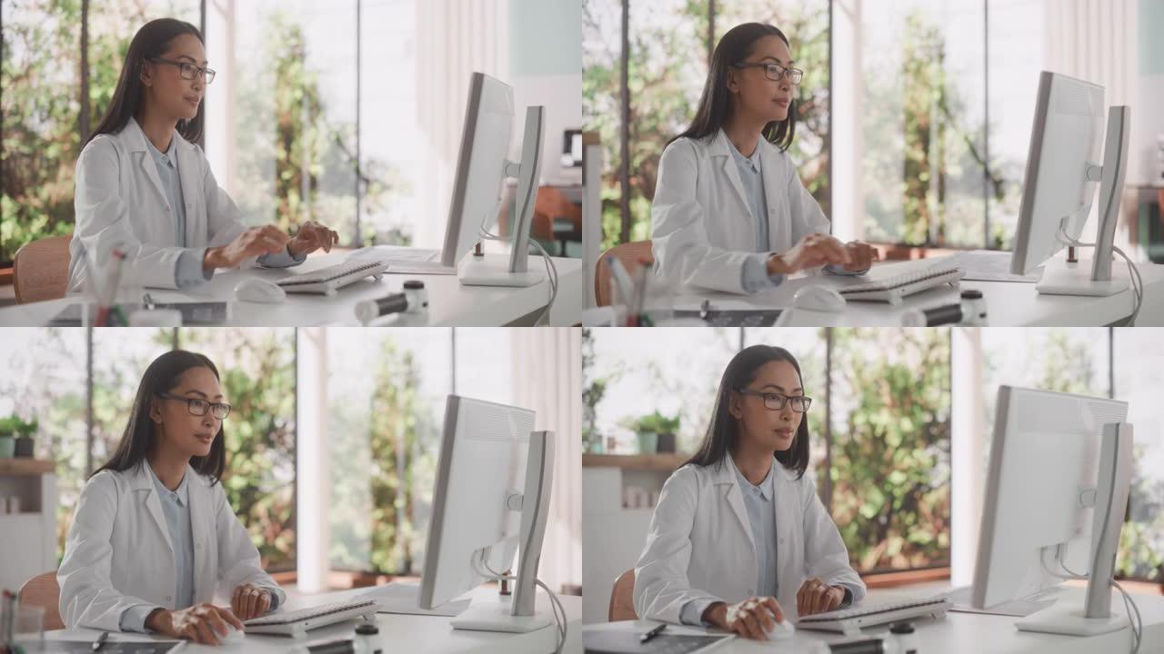一位亚洲医疗保健专业人员在医院办公室的台式计算机上工作的肖像。女诊所医师在线指定处方，更新电子健康记