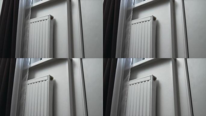 靠近窗户的壁式加热器的特写镜头。接近加热器。公寓内部。4K