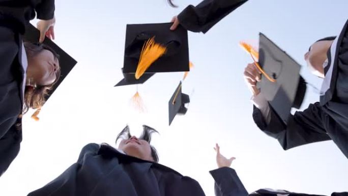 快乐的学生在空中扔毕业帽