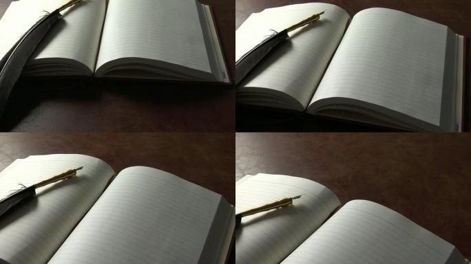 空白笔记本上的羽毛羽毛笔