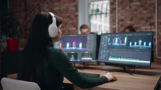 在后期制作工作室进行视频编辑，女人正在使用电影制作软件与计算机合作