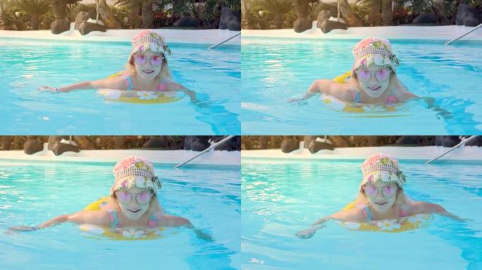度假酒店水上公园游泳池带充气环的快乐孩子
