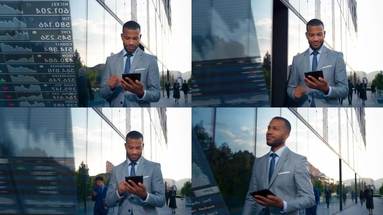 年轻的男性企业家在沿着现代商业大楼行走时，在他的数字平板电脑上检查交易应用程序