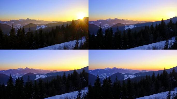 山地冬季景观中五彩缤纷的日落。晴朗的蓝天没有云。