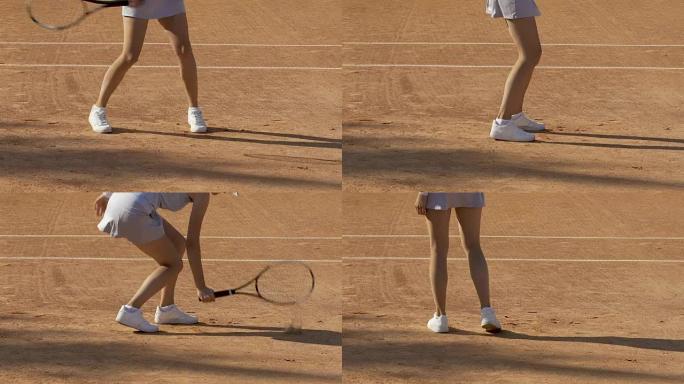 活跃的女人对网球比赛的得分感到失望，将球拍击中地面