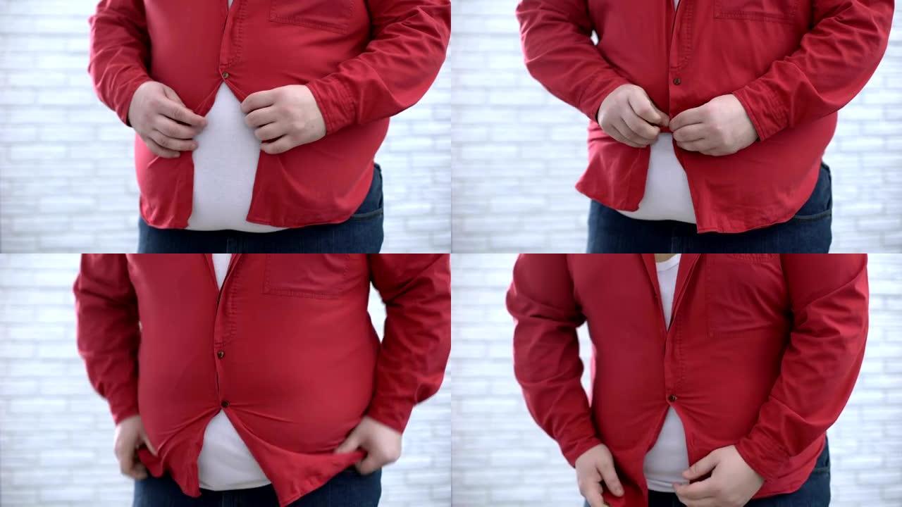 肥胖的男人试图扣上红色衬衫，外观不安全感，健康