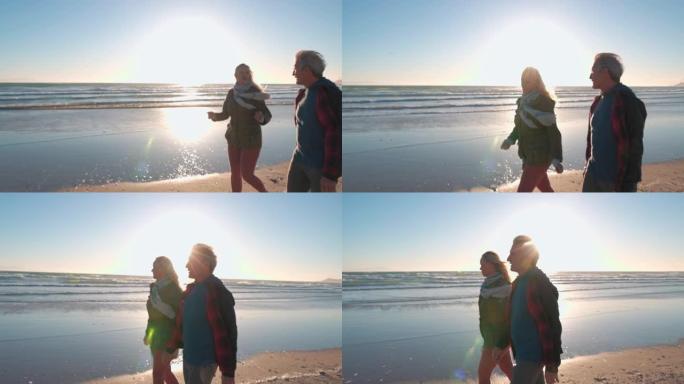 成熟的夫妇沿着空荡荡的海滩散步，有对流