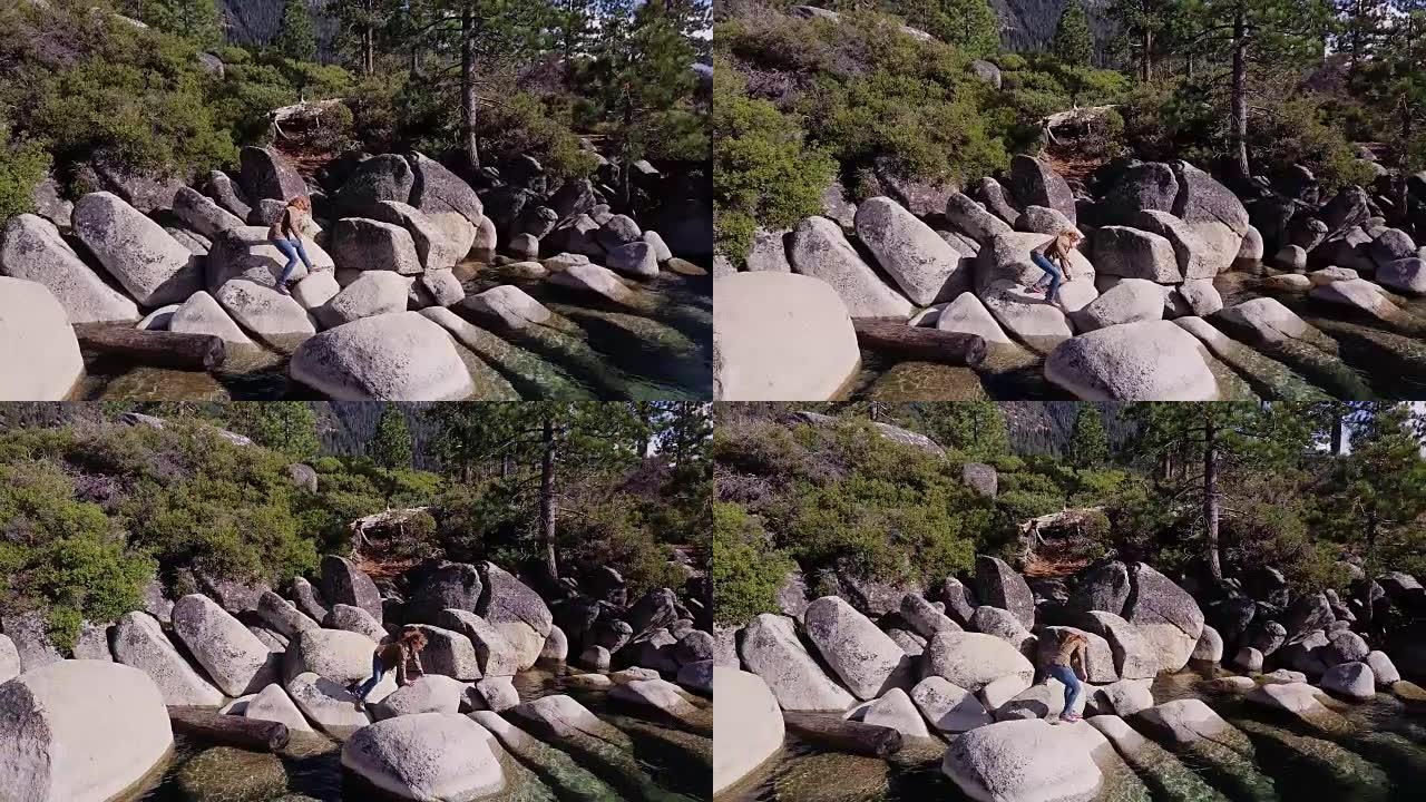 女人在太浩湖岸边的岩石上攀爬