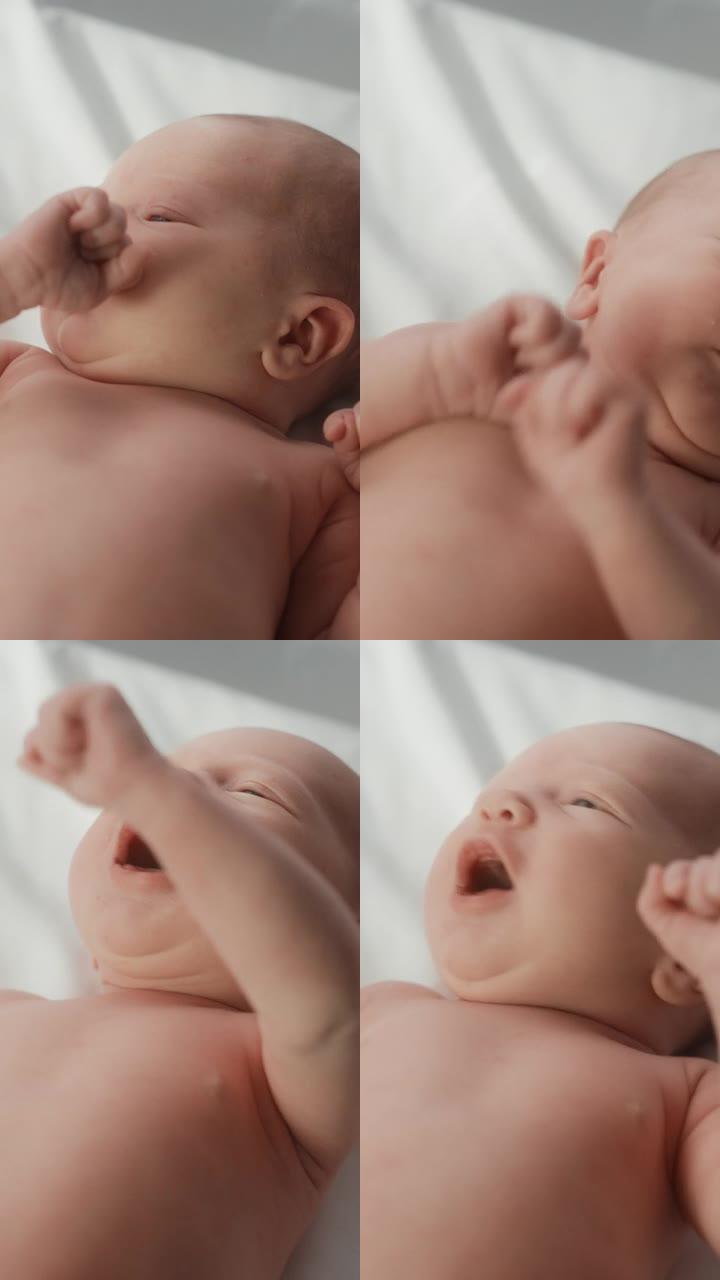 垂直屏幕: 婴儿出生后躺在产科病房摇篮中的婴儿的肖像。可爱的新生儿呼唤妈妈，感觉精力充沛，失眠